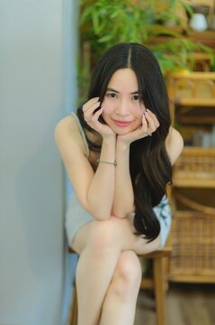 Young Woman Posing Thoughtfully in a Cozy Indoor Setting