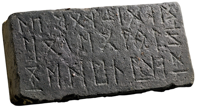Ancient stone tablet with carved runes
