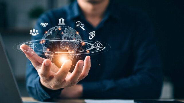 Businessman holding glowing digital hologram globe with global network and business icons
