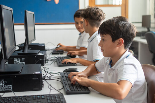 Elementary School Boys Using Desktop Computers in class