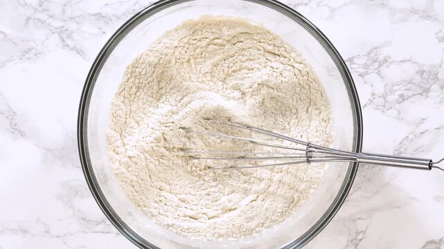 Whisk Resting in Bowl of Flour