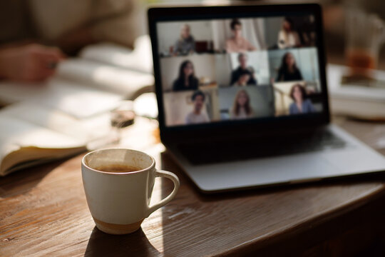 Virtual book club video call with coffee cup and laptop for online meeting background and remote discussion layout