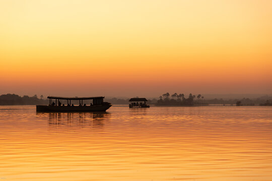 vintage boat on the Zambezi River at sunrise, Zambia, Africa