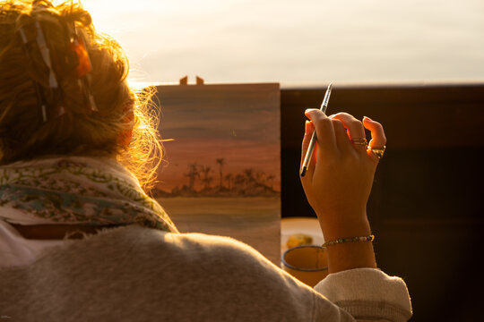 woman artist with acrylic colors on palette