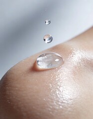 Fototapeta premium Clear Gel Droplet on Glowing Skin With Tiny Water Drops Macro