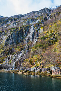 Steep rock face with a waterfall in Trollfjord in Norway