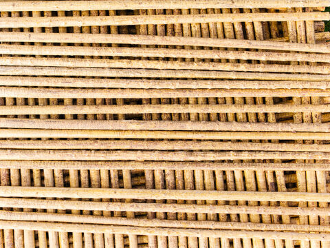 Aerial view of a stack of wooden poles arranged in a grid pattern in Brankas, Jelgava Municipality, Latvia.