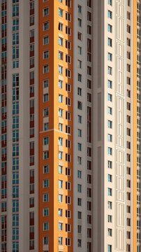 Tall modern building exterior features orange and white architectural panels