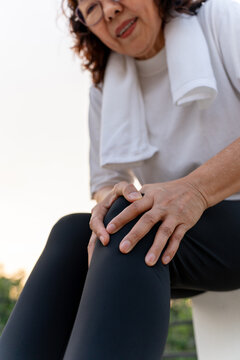 Elderly woman hand massaging her leg suffering leg pain showing senior health problems with muscle pain and joint stiffness, insurance in retirement for wellbeing and quality of life.