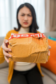 Asian women ordered household items plates and ceramic cups online. The packages arrived damaged dented and broken. Online shopping packages damaged due to the shipping system require a claim.