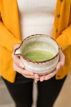 Asian women are brewing their own matcha tea at home for health benefits. Matcha is a healthy drink with reduced sugar content.