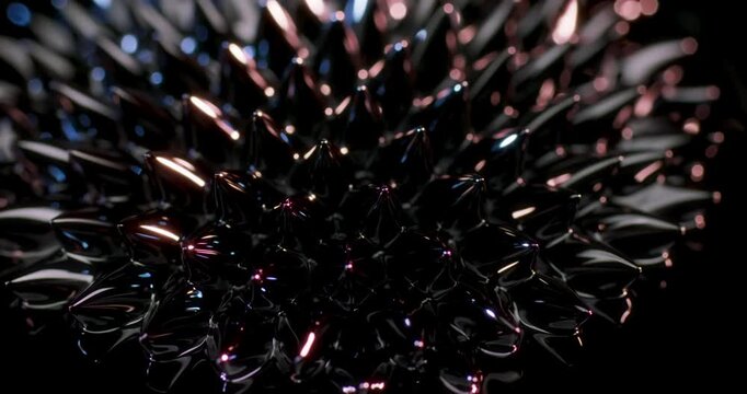 The mesmerizing and captivating abstract shapes created by ferrofluid on a sleek black background are perfect for use in motion graphics and various visual effects for a modern artistic presentation