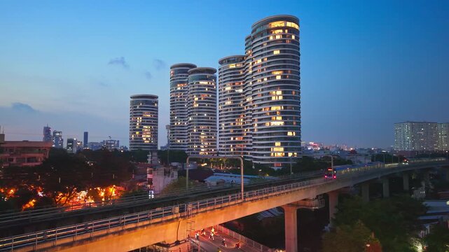 Ho Chi Minh City Metro Train passing City Garden Luxury Residential Towers at blue hour, Vietnam