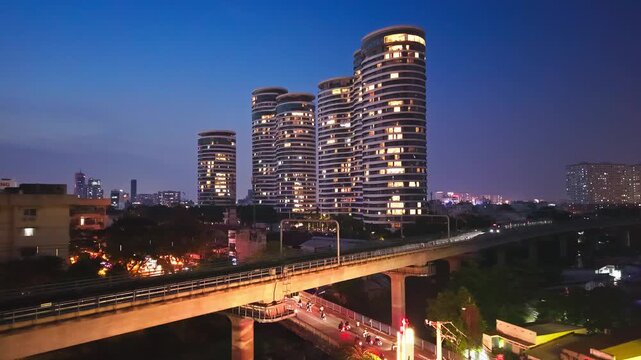 Ho Chi Minh City Metro Train passing City Garden Luxury Residential Towers at blue hour, Vietnam