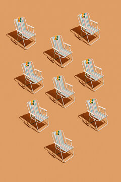 Striped beach chair arrangement features pineapple sunglasses