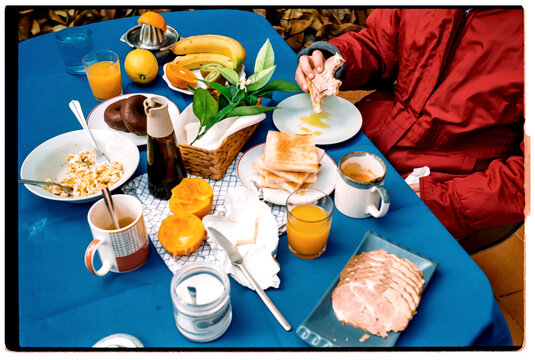 A breakfast table displays fresh fruit and toast in the morning
