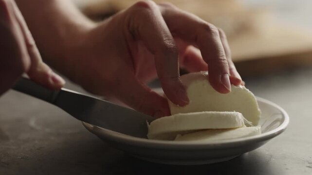 slicing mozzarella ball close up