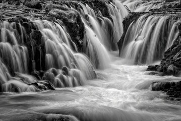 Black and white photo of a waterfall flowing over rocks © Daniel