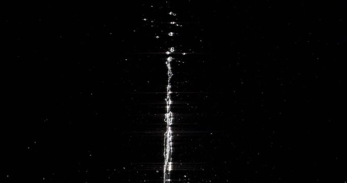 This slowmotion footage showcases the beauty of water droplets splashing and scattering after an object hits the surface, perfect for enhancing motion graphics and creating visual effects