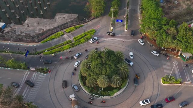 Lanco Hills Big Circle with traffic flow, rumble strips, trees and street lights at manikonda, hyderabad, telangana, india. day time, crane shot, drone shot, 4k.