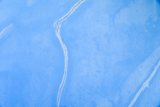 Close-up of Blue Painted Surface with Cracks and Texture Details