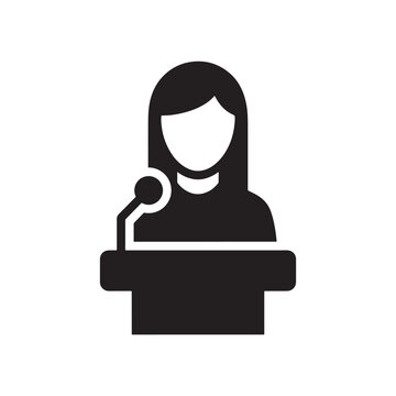 Professional female speaker presenting at a conference event from a podium with a microphone silhouette icon