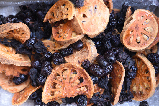 Dried Bael Fruit Slices and Black Jujube Berries Close-Up