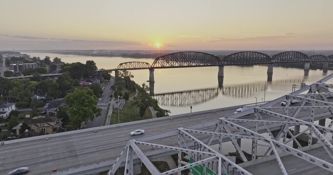 Louisville Kentucky Aerial v55 drone low flyover interstate freeway and big four bridges over the Ohio river with beautiful sun rising on the horizon  - Shot with Mavic 3 Pro Cine - Sept 26th 2023
