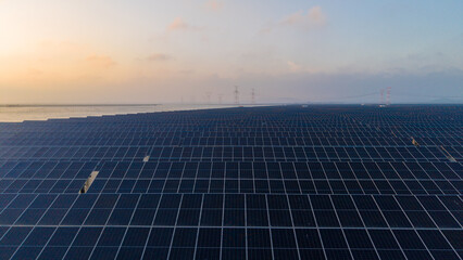 Large Scale Solar Photovoltaic Farm At Dusk Near Water © Zhaorui