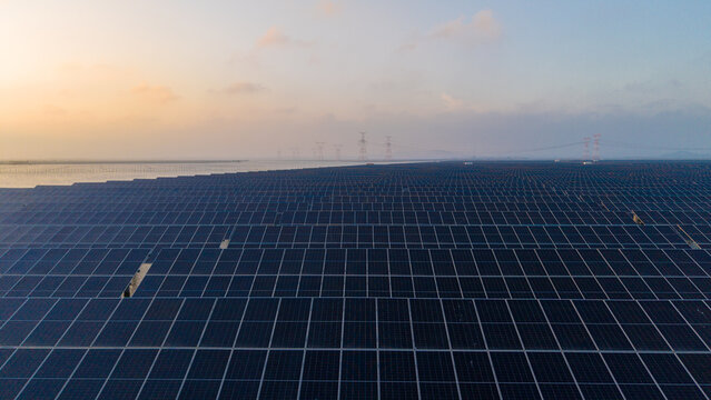 Large Scale Solar Photovoltaic Farm At Dusk Near Water