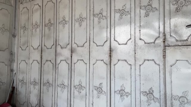 Vintage folding iron gate with classic decorative ornaments