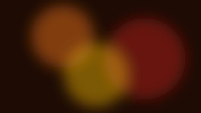 Abstract soft glowing orange and deep red bokeh light orbs on dark background