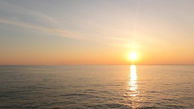 Real-time maritime sunrise footage with perfect copyspace for text under a soft pastel twilight sky
