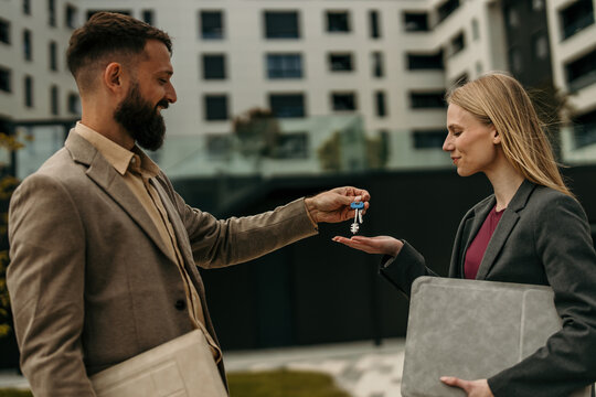 Real estate agent handing keys to new homeowner
