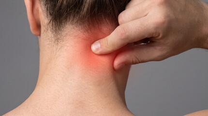 Naklejka premium Person touching their painful neck area with a bright red glow indicating severe muscle tension