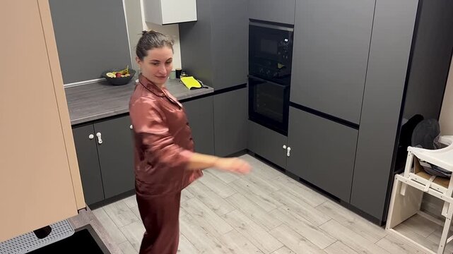 Happy woman dancing in pajamas at home, authentic smartphone video