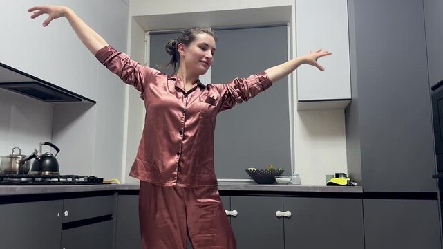 Happy woman dancing in pajamas at home, authentic smartphone video