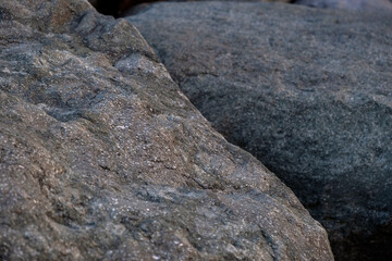 Close up abstract of large rough grey boulder structures © Maria