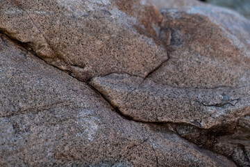 Close up abstract of large rough grey boulder structures © Maria