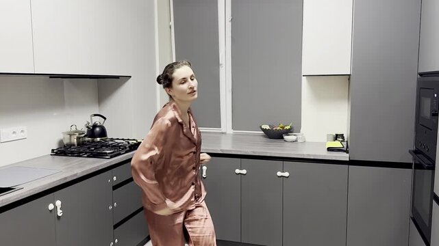 Happy woman dancing in pajamas at home, authentic smartphone video