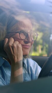 Sad frustrated Caucasian old senior aged woman looking in mobile phone in car retired female losing with smartphone bet failure online in auto lady driver reading online bad news message in automobile