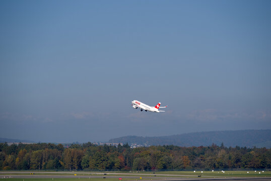 Swiss passenger airplane type Airbus A220-100 registration HB-JBF taking off from Swiss Z&uuml;rich Airport on a sunny autumn day. Photo taken October 18th, 2025, Zurich Airport, Switzerland.
