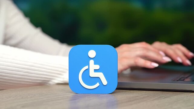 A symbol of a person with a disability and a woman working on a laptop. Social support services for people with special needs. Support service.
