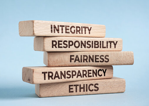 Stacking wooden blocks showing integrity responsibility fairness transparency ethics