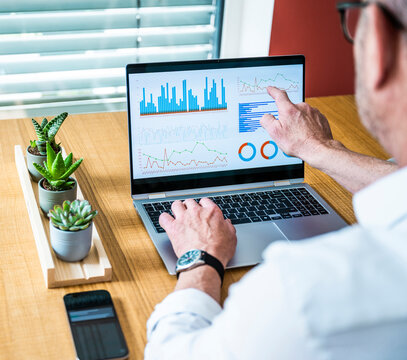 Businessman analyzes financial data on a notebook in the office