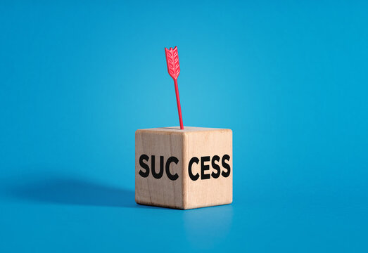 Red arrow hitting wooden block success concept, achieving success.