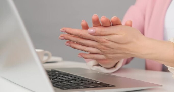Close up hands typing on laptop then sanitizing for hygiene and health precautions.