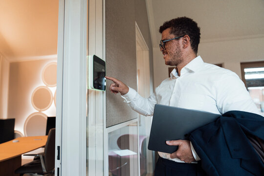 A businessman uses a touchscreen panel at the office