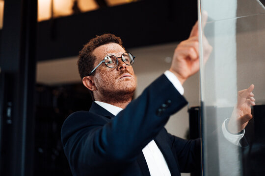 Businessman with freckles uses a touchscreen in the office