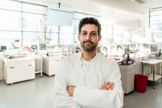 Confident doctor in modern laboratory looking at camera